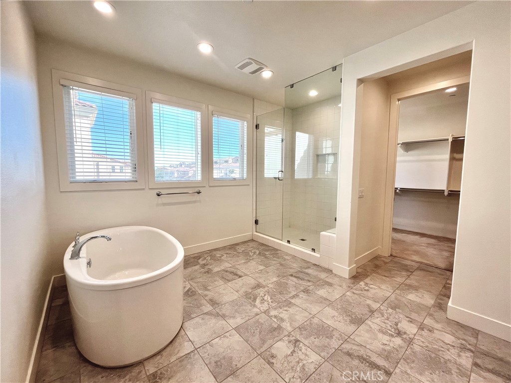 12040 Estrella Place Porter Ranch, CA 91326 - Photo 12 of 25 a bathroom with a tub and a shower