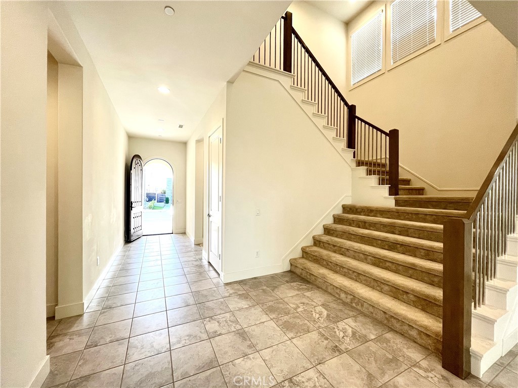 12040 Estrella Place Porter Ranch, CA 91326 - Photo 13 of 32 a view of entryway and hall with wooden floor