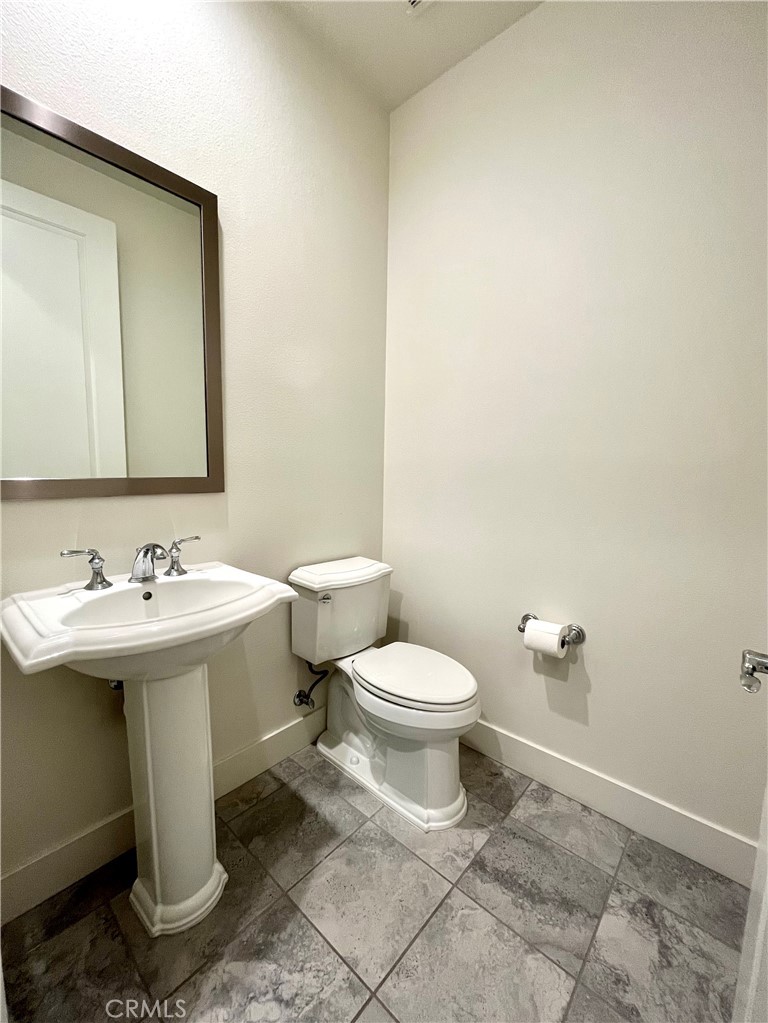 12040 Estrella Place Porter Ranch, CA 91326 - Photo 15 of 25 a bathroom with a sink and mirror with toilet