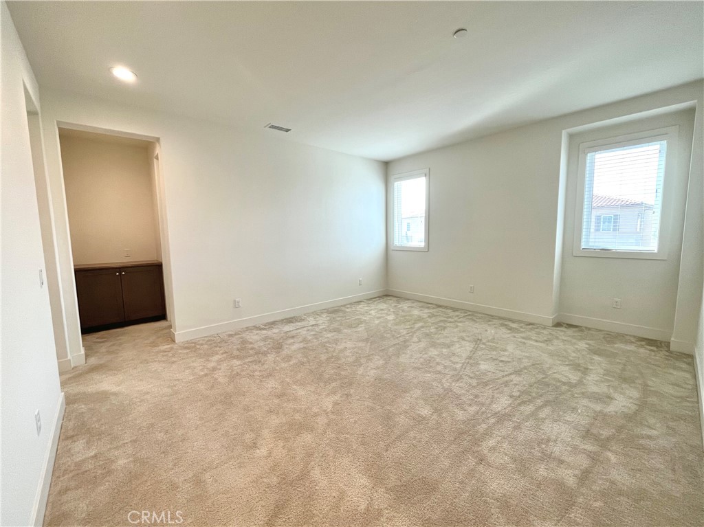 12040 Estrella Place Porter Ranch, CA 91326 - Photo 16 of 32 an empty room with windows