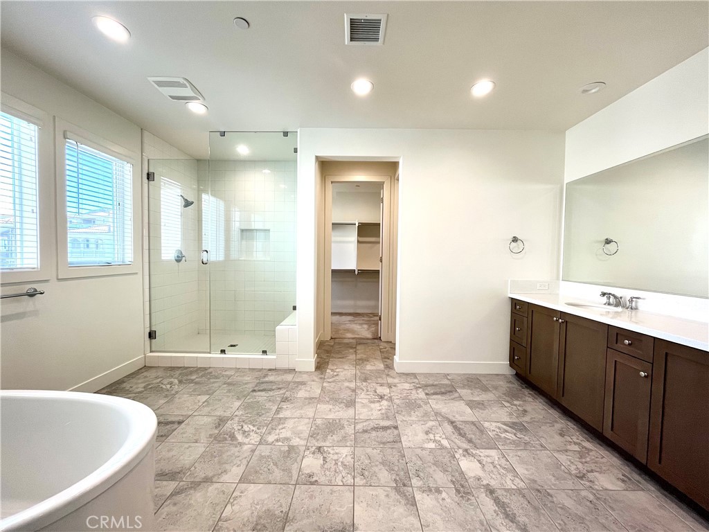12040 Estrella Place Porter Ranch, CA 91326 - Photo 17 of 32 a bathroom with a bathtub sink and mirror