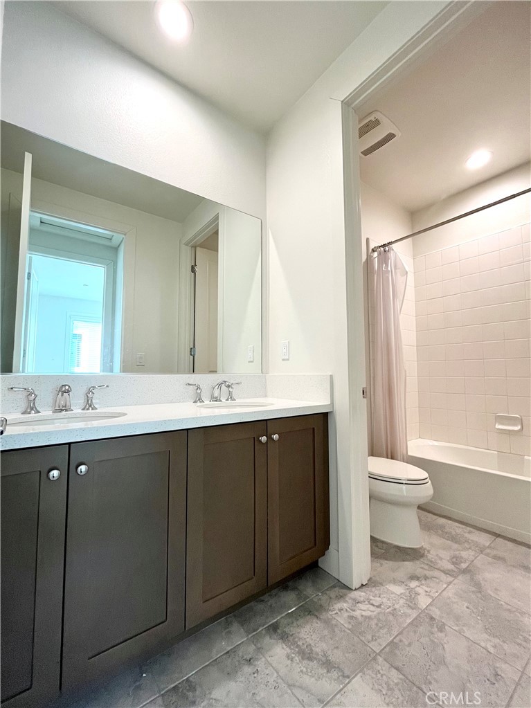 12040 Estrella Place Porter Ranch, CA 91326 - Photo 18 of 25 a bathroom with a double vanity sink toilet and a tub