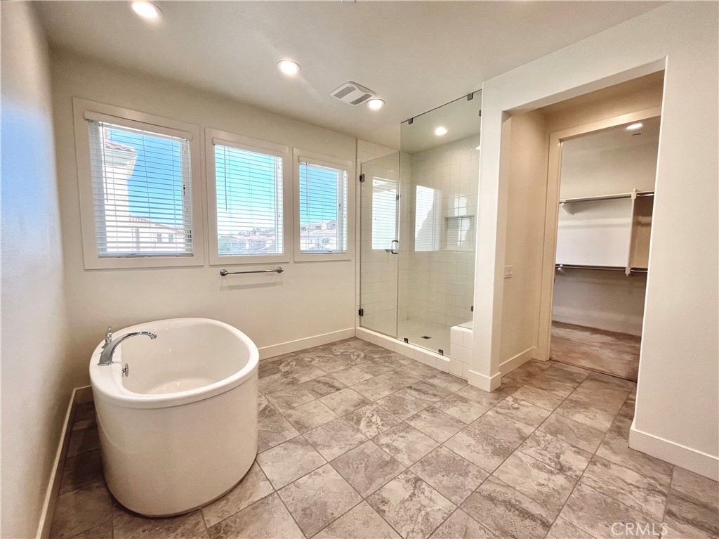 12040 Estrella Place Porter Ranch, CA 91326 - Photo 18 of 32 a bathroom with a tub and a shower