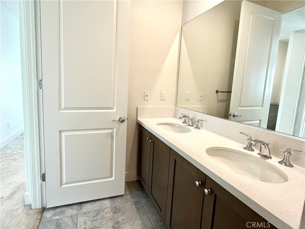 12040 Estrella Place Porter Ranch, CA 91326 - Photo 19 of 25 a bathroom with a sink and a mirror