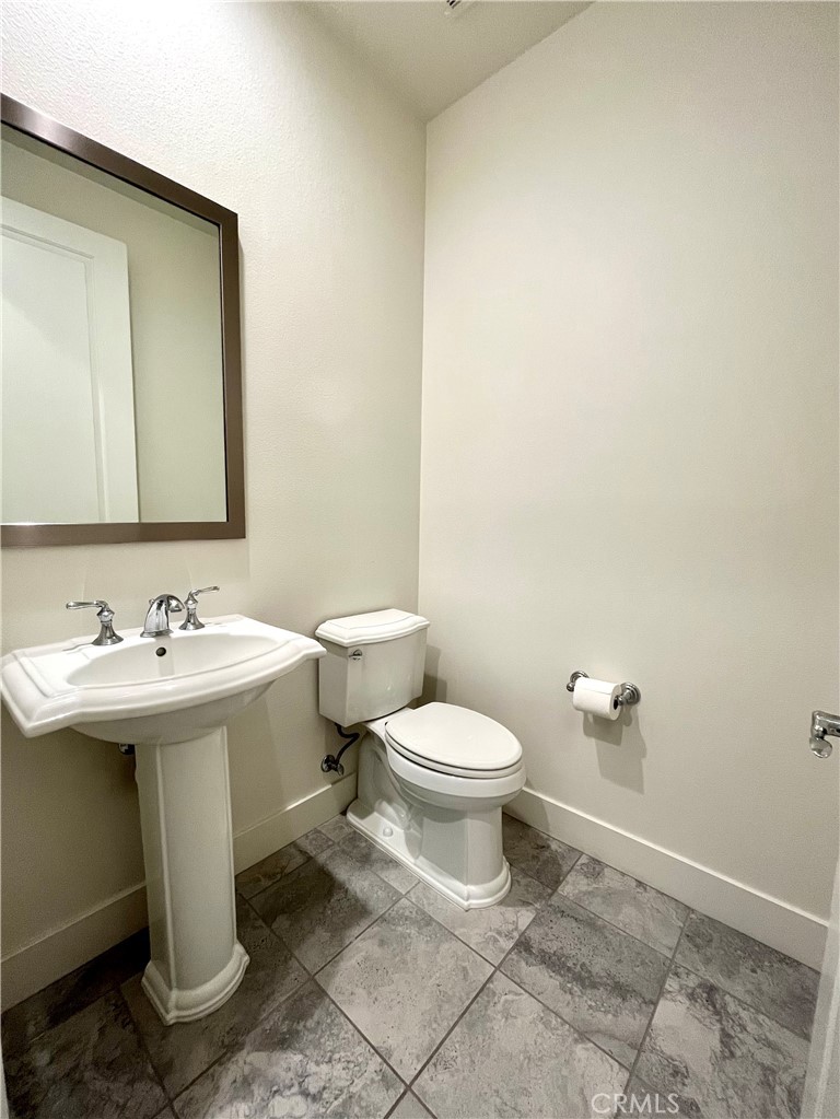 12040 Estrella Place Porter Ranch, CA 91326 - Photo 21 of 32 a bathroom with a sink and mirror with toilet