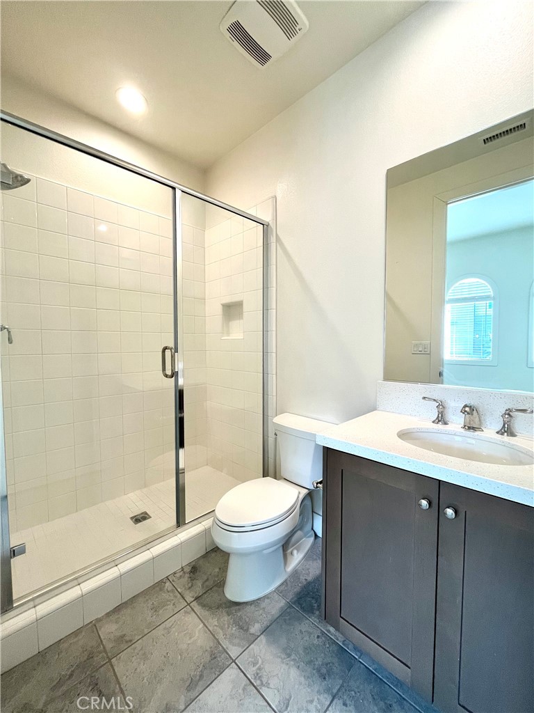 12040 Estrella Place Porter Ranch, CA 91326 - Photo 22 of 32 a bathroom with a bathtub shower sink mirror and toilet