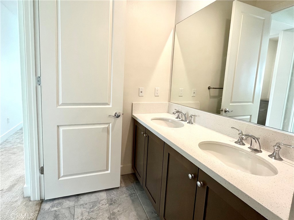 12040 Estrella Place Porter Ranch, CA 91326 - Photo 25 of 32 a bathroom with a sink and a mirror