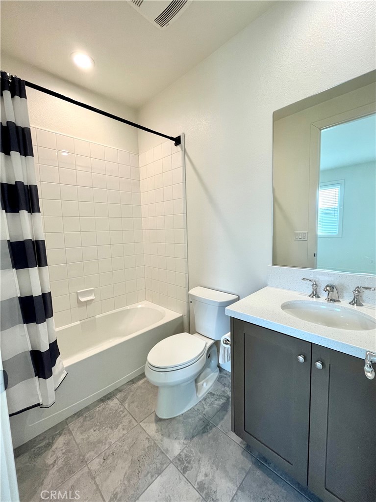 12040 Estrella Place Porter Ranch, CA 91326 - Photo 27 of 32 a bathroom with a sink a toilet a mirror a bathtub and shower
