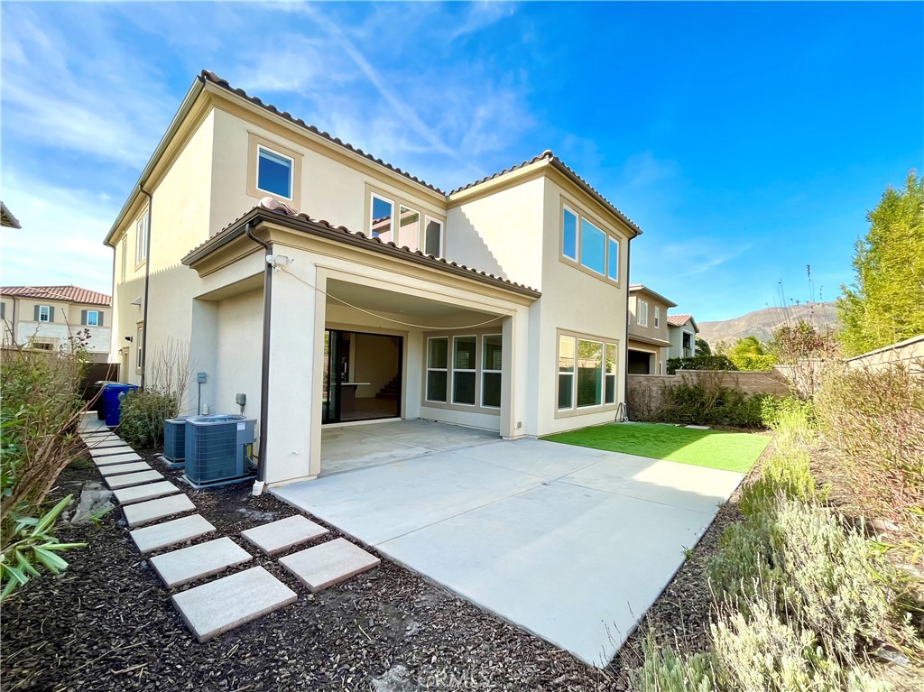 12040 Estrella Place Porter Ranch, CA 91326 - Photo 30 of 32 a view of a house with backyard and porch