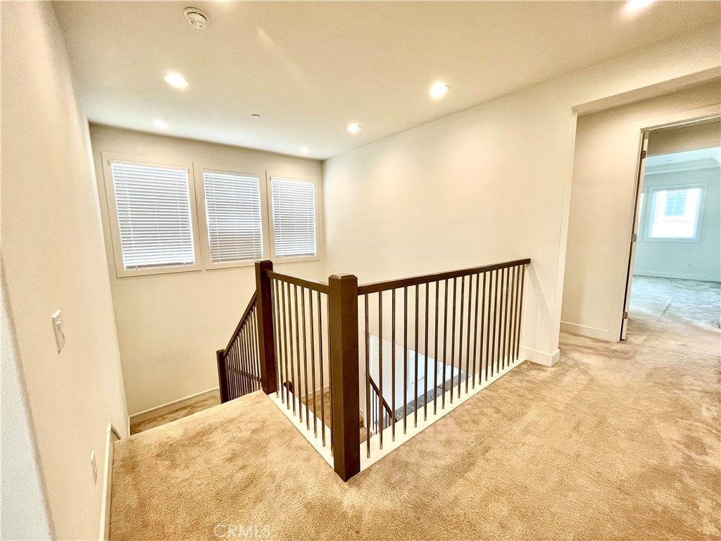 12040 Estrella Place Porter Ranch, CA 91326 - Photo 8 of 25 a view of a hallway with a bedroom