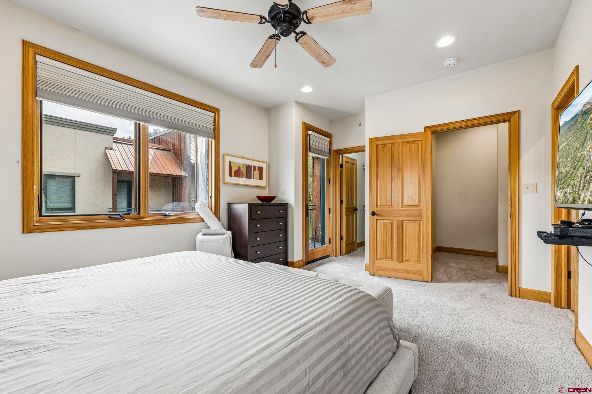 1422 Animas View Drive, Unit 55 Durango, CO 81301 - Photo 20 of 44 a bedroom with a bed and a chandelier
