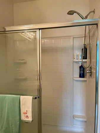 a bathroom with a glass shower door