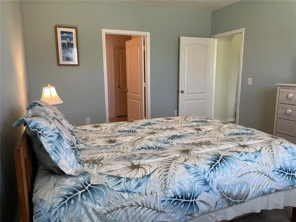 a bedroom with a bed and a lamp