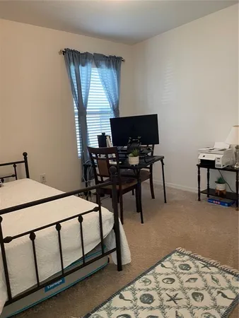 a bedroom with furniture and a window