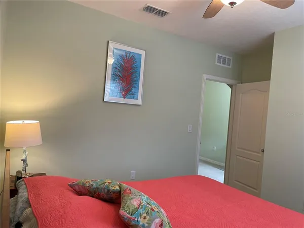 a bedroom with a bed and a lamp