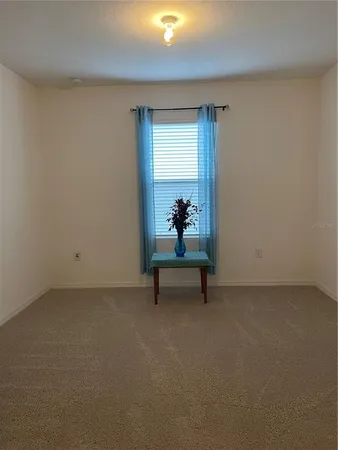 a bench sitting in a room next to a window