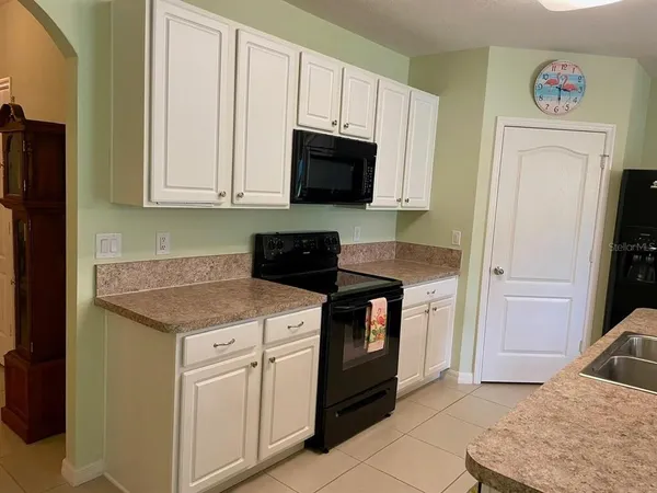a kitchen with stainless steel appliances granite countertop a stove a microwave and a refrigerator