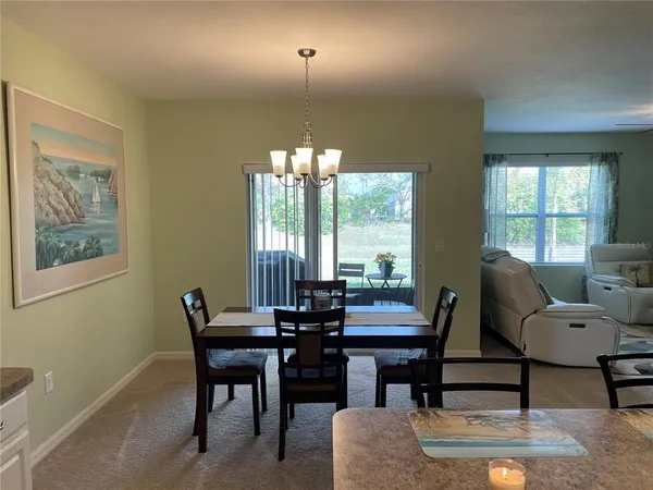 a view of a dining room with furniture and window
