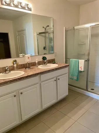 a spacious bathroom with a double vanity sink mirror and