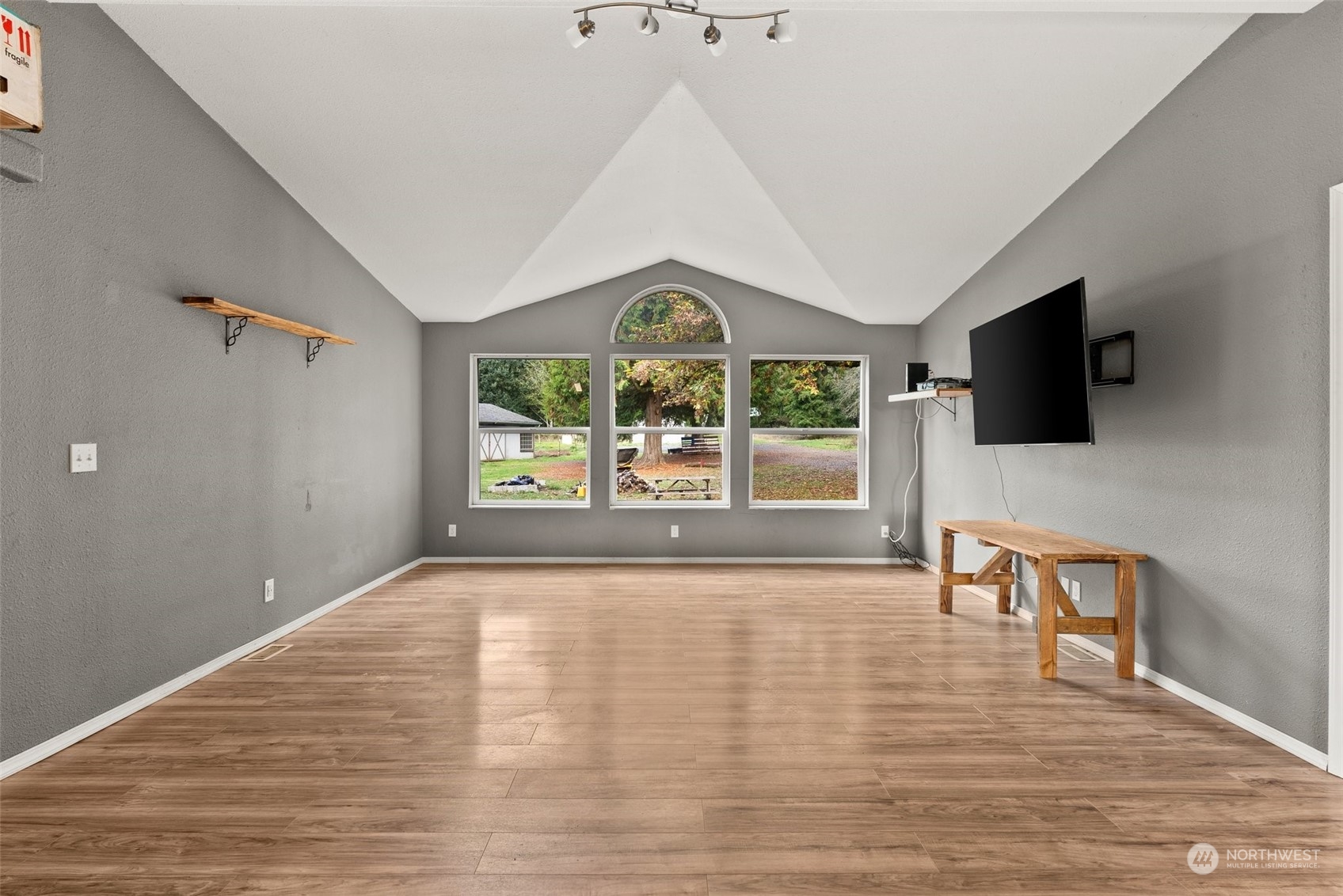 138 Pleasant Valley Road Winlock, WA 98596 - Photo 6 of 34 a view of an empty room with a window and wooden floor