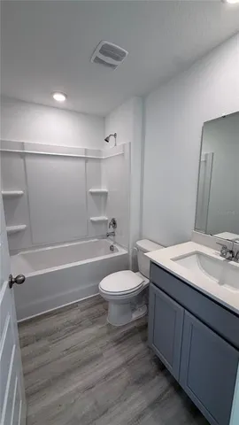 a bathroom with a toilet a sink and bathtub