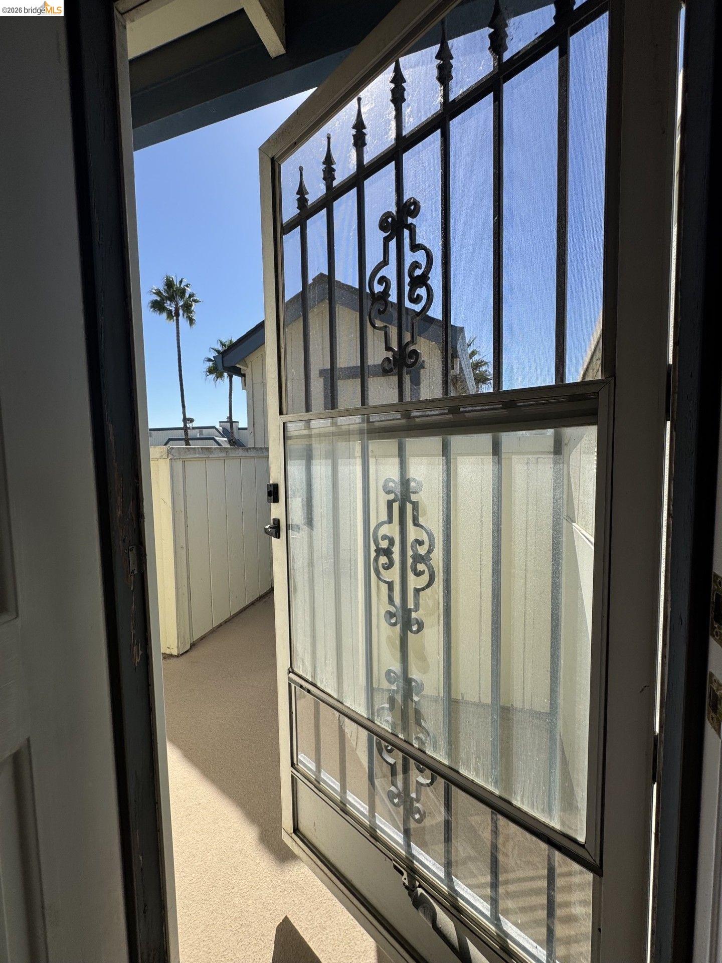 3623 Wells Road Oakley, CA 94561 - Photo 43 of 75 Wrought iron security door with ornamental detailing, clear screen panel, and light-colored exterior flooring