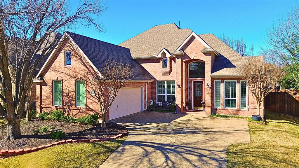 a view of a white house with a swimming pool table and chairs