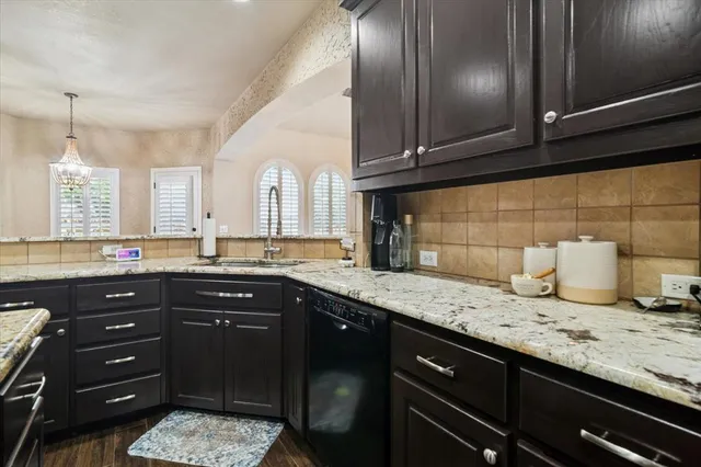 a kitchen with granite countertop stainless steel appliances and sink