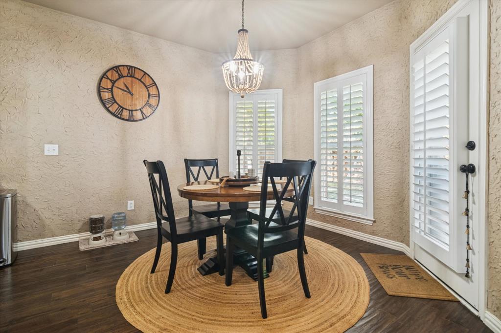 1602 Crown Point Road McKinney, TX 75072 - Photo 16 of 40 a view of a dining room with furniture window and wooden floor