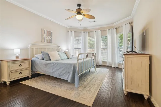 a spacious bedroom with a bed and a chandelier
