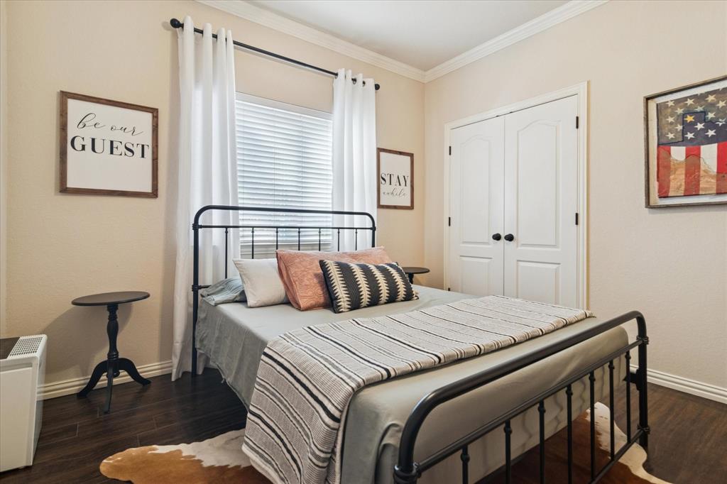 1602 Crown Point Road McKinney, TX 75072 - Photo 24 of 40 a bedroom with a bed and a table in it