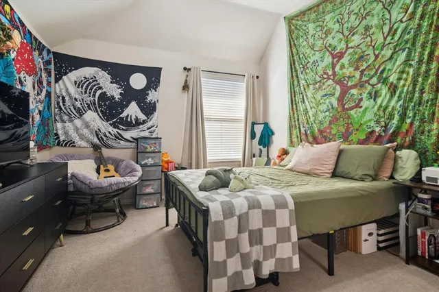 a bedroom with a bed and a couch