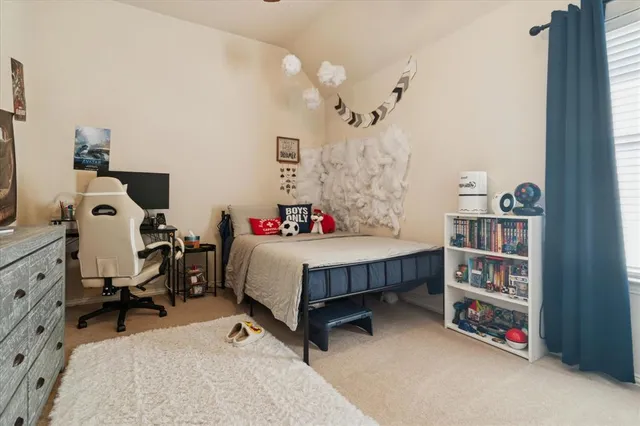 a bed room with a bed and a chair