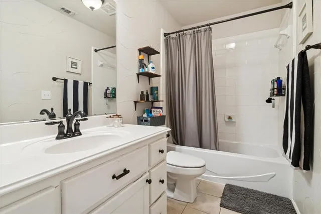a bathroom with a sink a toilet a mirror and shower