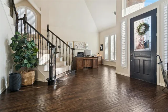 a view of a livingroom with wooden floor and stairs