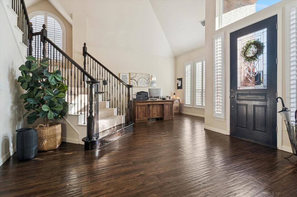1602 Crown Point Road McKinney, TX 75072 - Photo 4 of 40 a view of a livingroom with wooden floor and stairs