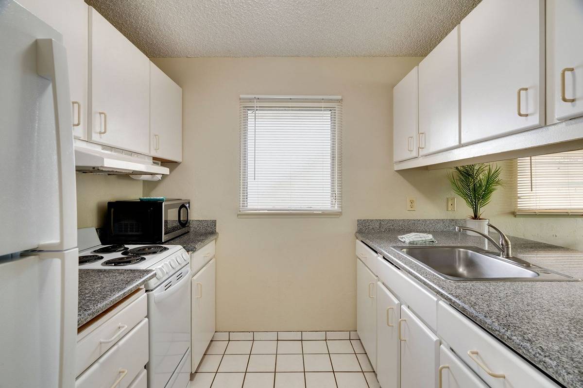 525 Aleka Loop, Unit C5 Kapaa, HI 96746 - Photo 9 of 24 a kitchen with granite countertop a sink a stove and cabinets