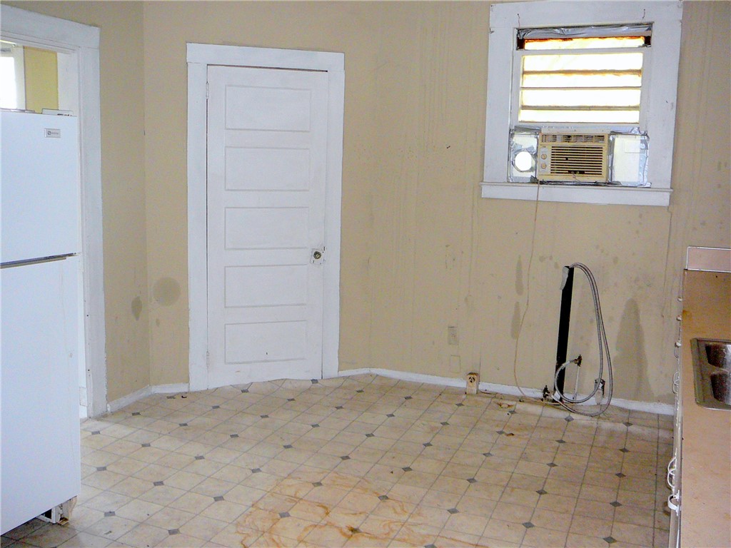 213 K Street Anderson, SC 29625 - Photo 6 of 8 A well-lit kitchen with classic tiled flooring, ready for a modern upgrade.
