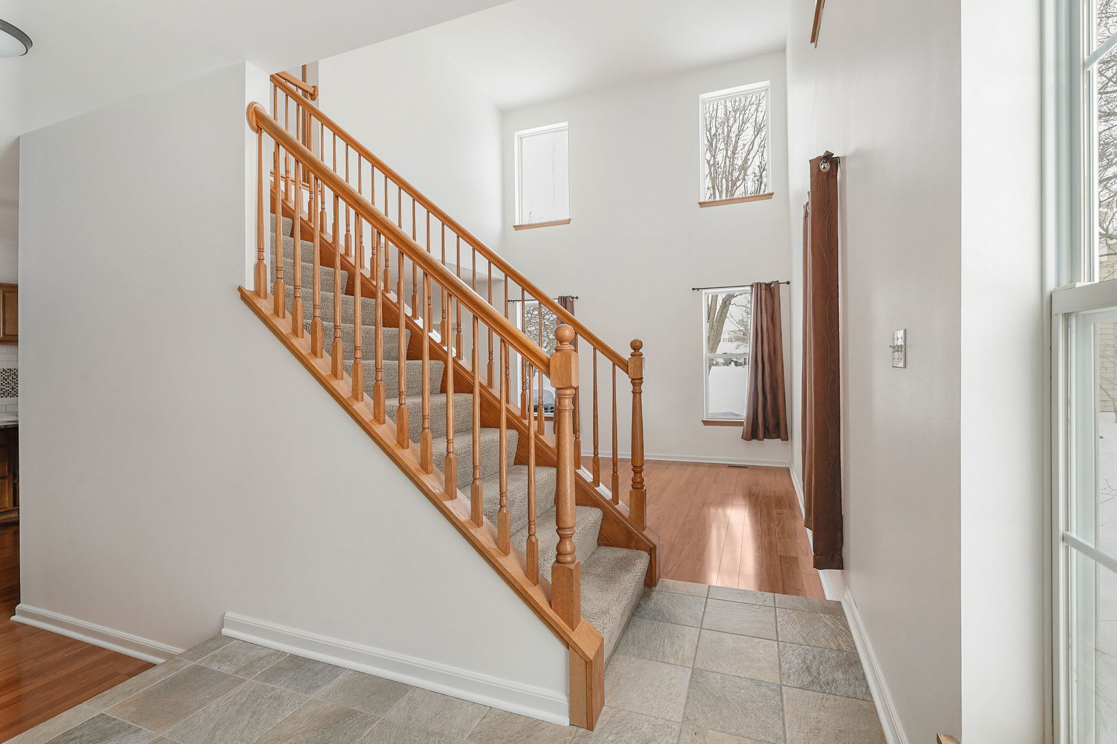 1529 Keystone Court Elgin, IL 60120 - Photo 20 of 22 a view of a hallway with wooden floor and staircase