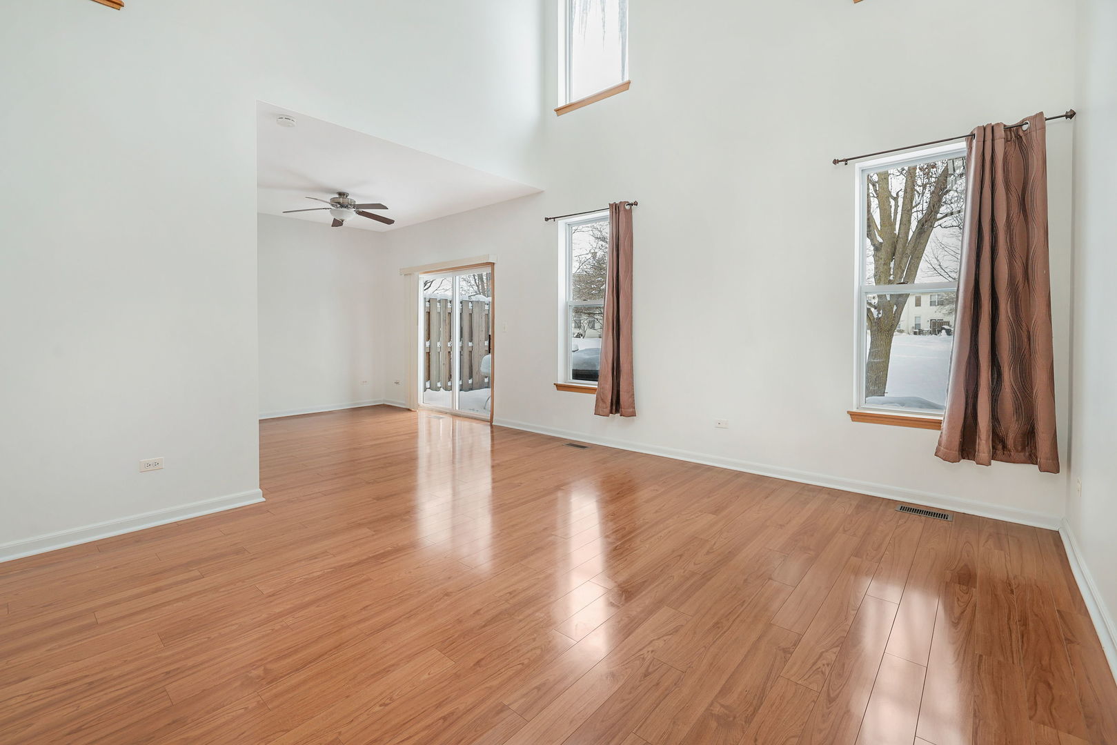 1529 Keystone Court Elgin, IL 60120 - Photo 2 of 22 a view of an empty room with wooden floor and a window