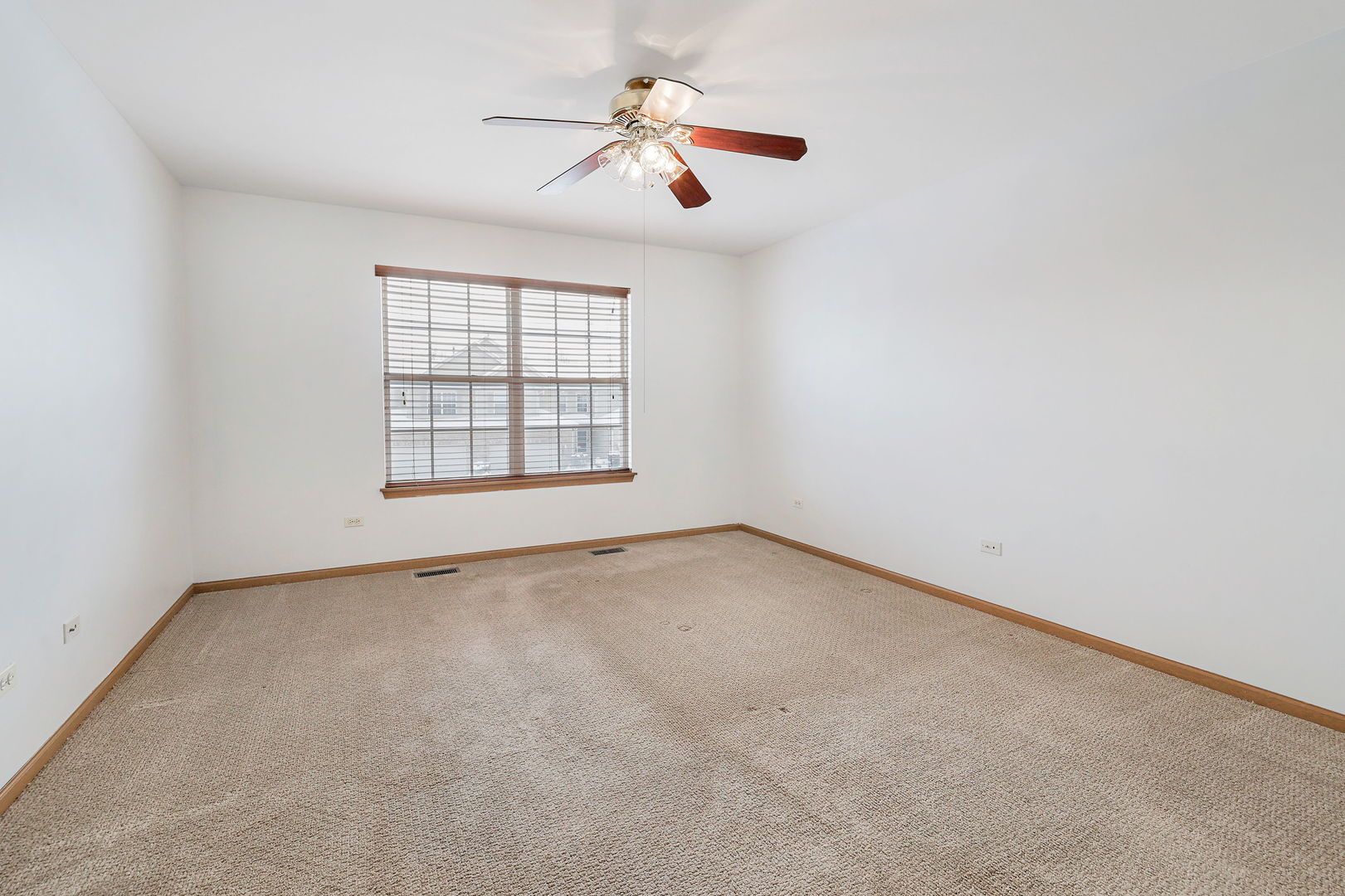 1529 Keystone Court Elgin, IL 60120 - Photo 10 of 22 an empty room with ceiling fan and windows