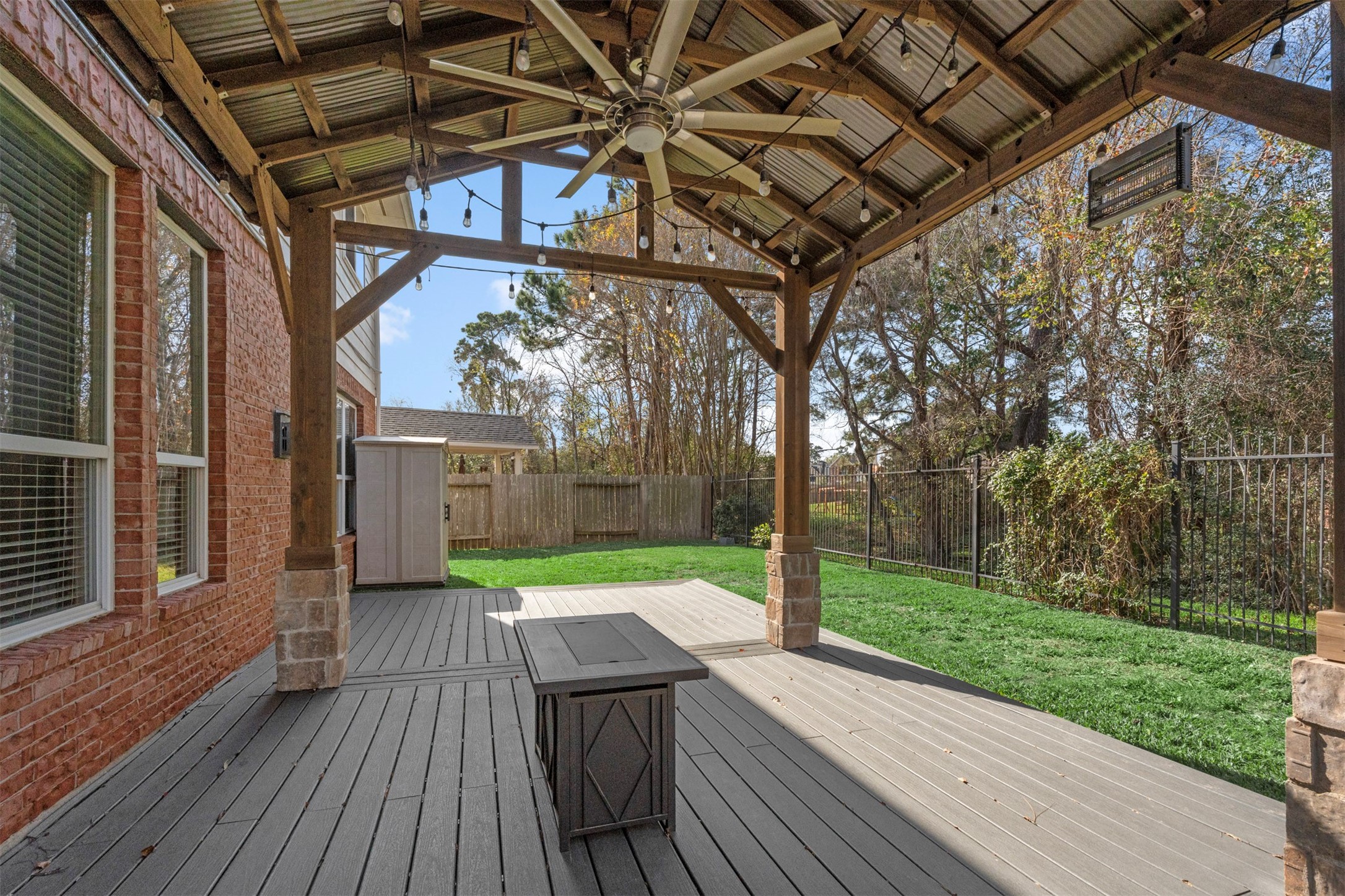 6326 Cash Oaks Drive Spring, TX 77379 - Photo 46 of 49 Covered patio with large ceiling fan, lights and propane fire pit and storage shed.