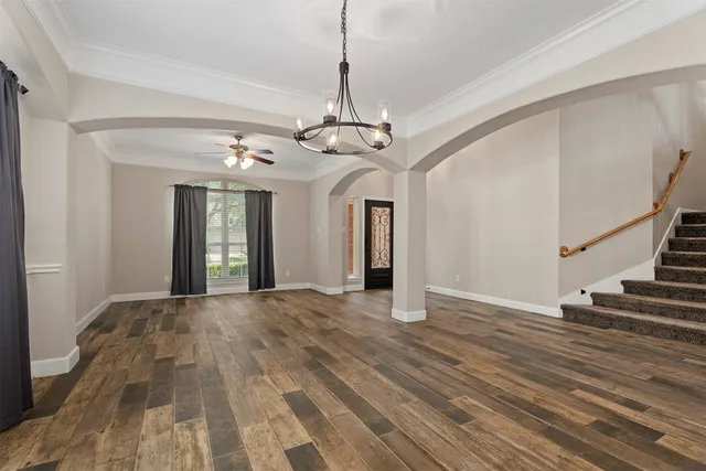 a living room with stainless steel appliances kitchen island furniture and a window