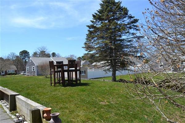 7 Knox Road Dennis, MA 02639 - Photo 21 of 22 a view of a garden with a bench in a garden