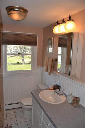 7 Knox Road Dennis, MA 02639 - Photo 9 of 22 a bathroom with a toilet sink and mirror