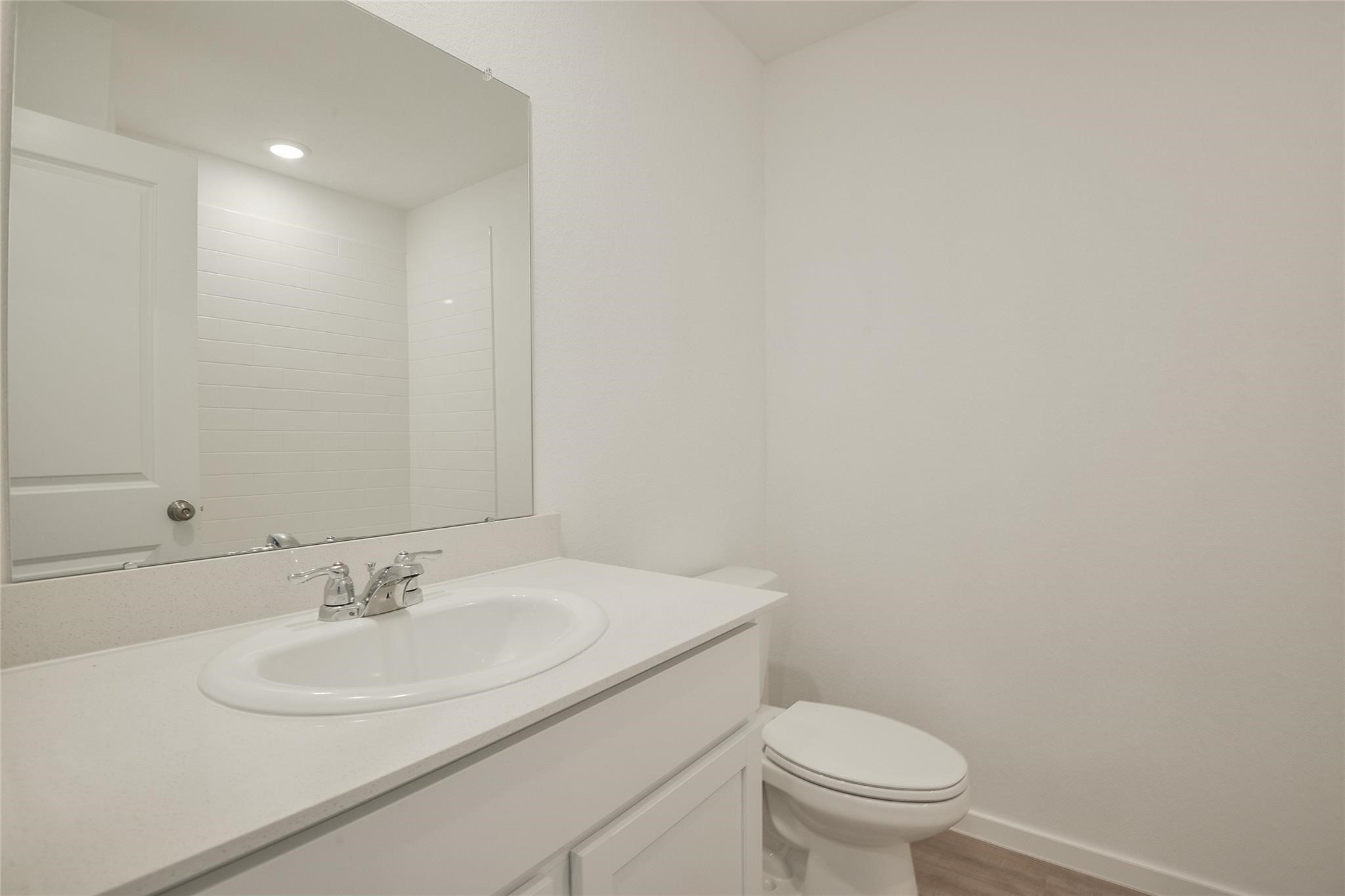 13746 Kit Run Splendora, TX 77372 - Photo 17 of 22 a bathroom with a sink a toilet and a mirror