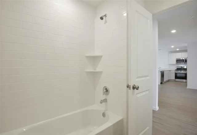 a bathroom with a bathtub and a shower