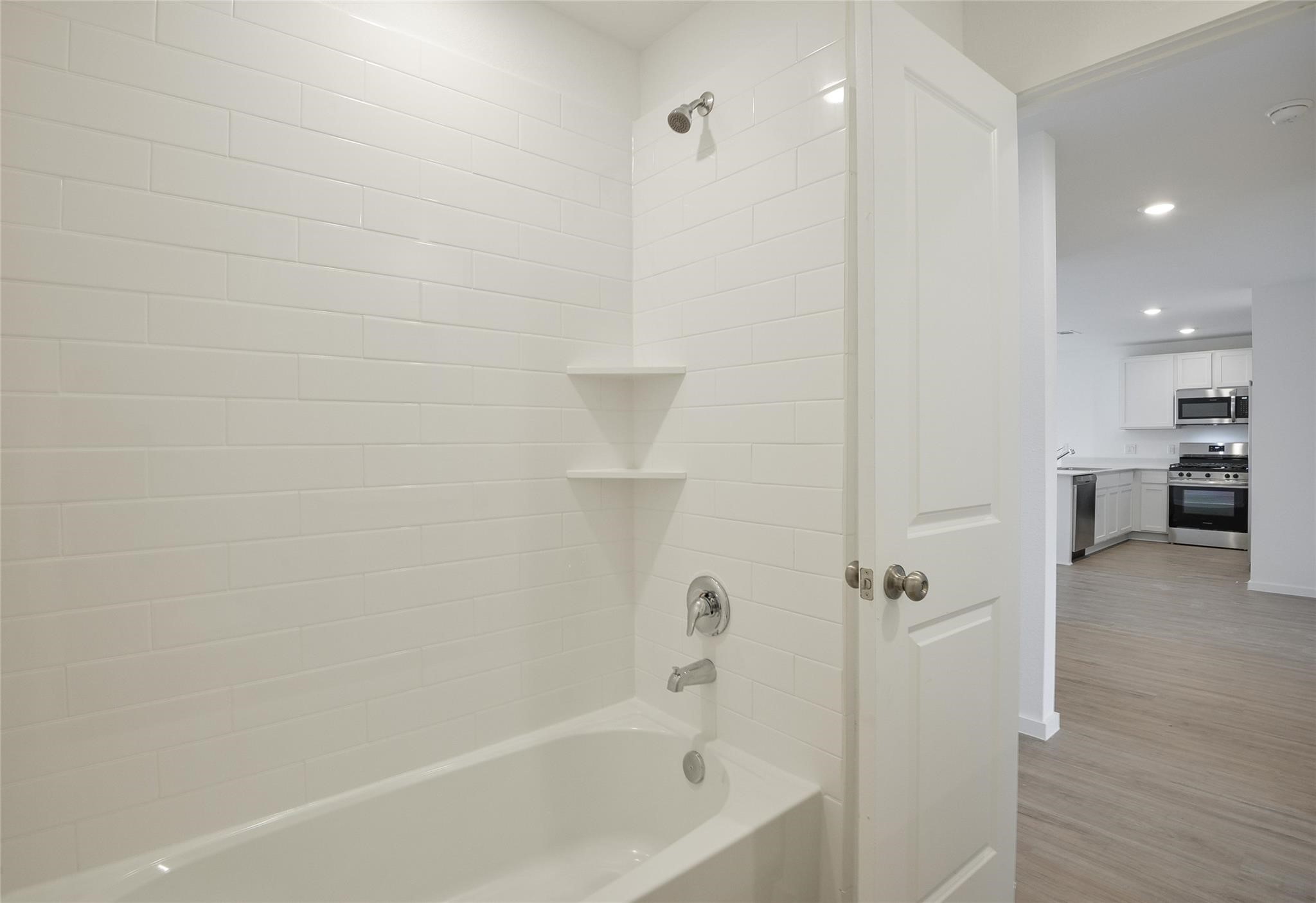 13746 Kit Run Splendora, TX 77372 - Photo 18 of 22 a bathroom with a bathtub and a shower