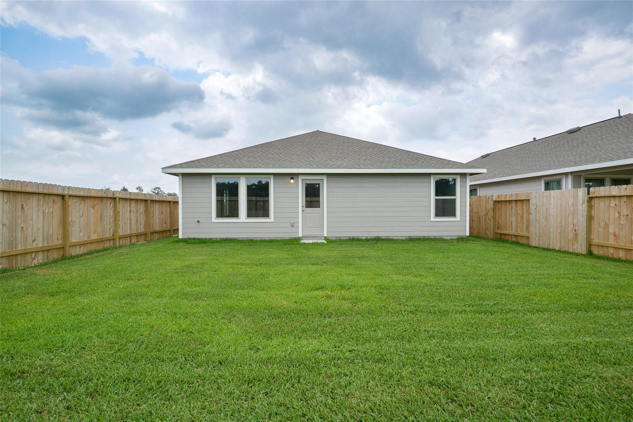13746 Kit Run Splendora, TX 77372 - Photo 22 of 22 a backyard of a house with lots of green space