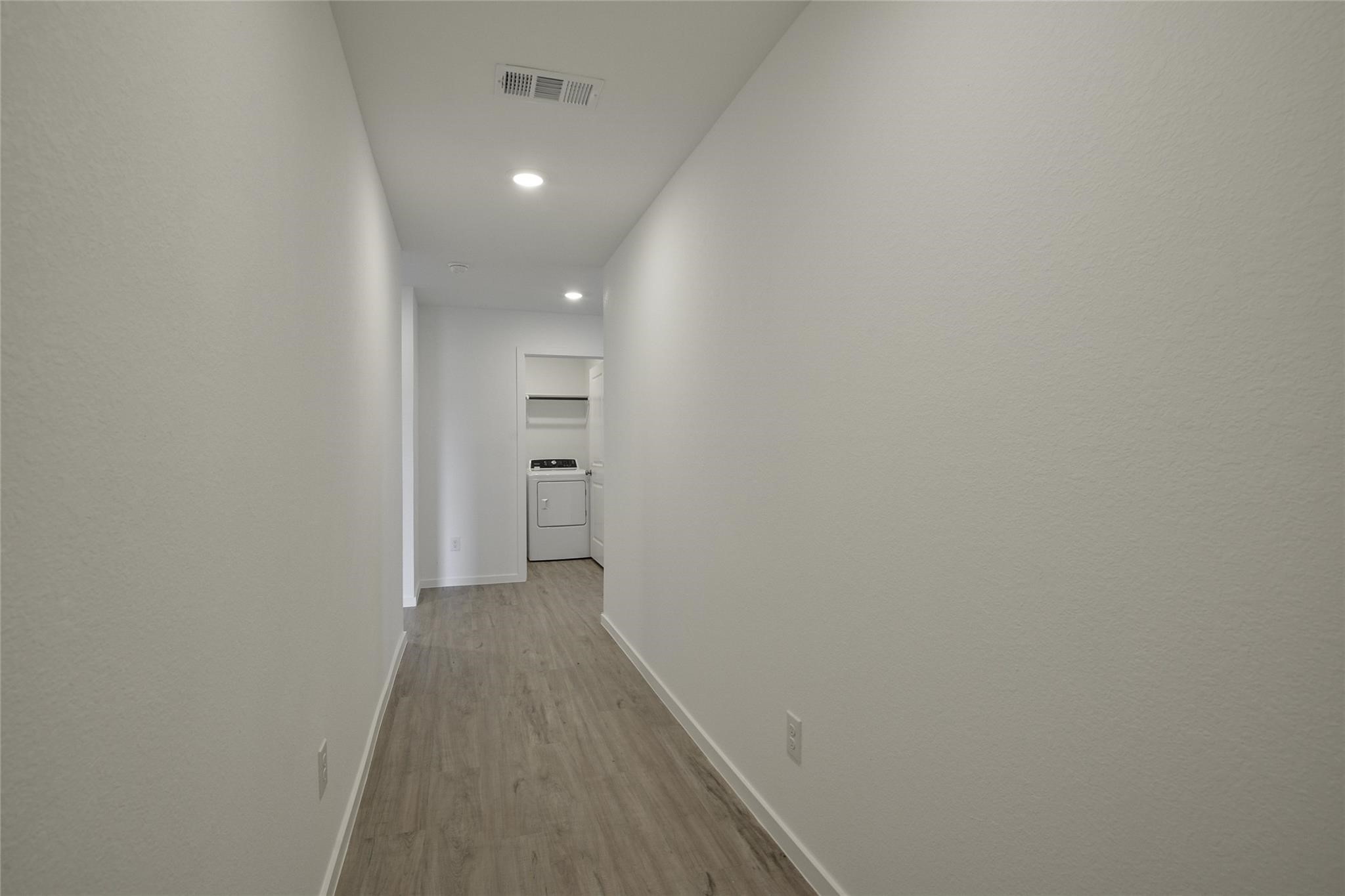 13746 Kit Run Splendora, TX 77372 - Photo 3 of 22 a view of a hallway with wooden floor